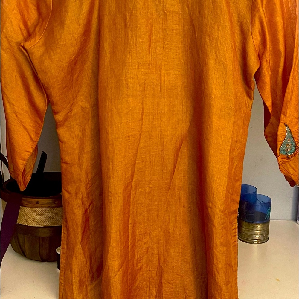 Long sleeves, gold like metallic color, sheer